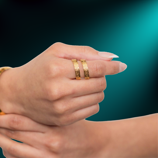 Hand wearing the NUUR Ayatul Kursi wrap ring in the 18K gold plated finish, close-up