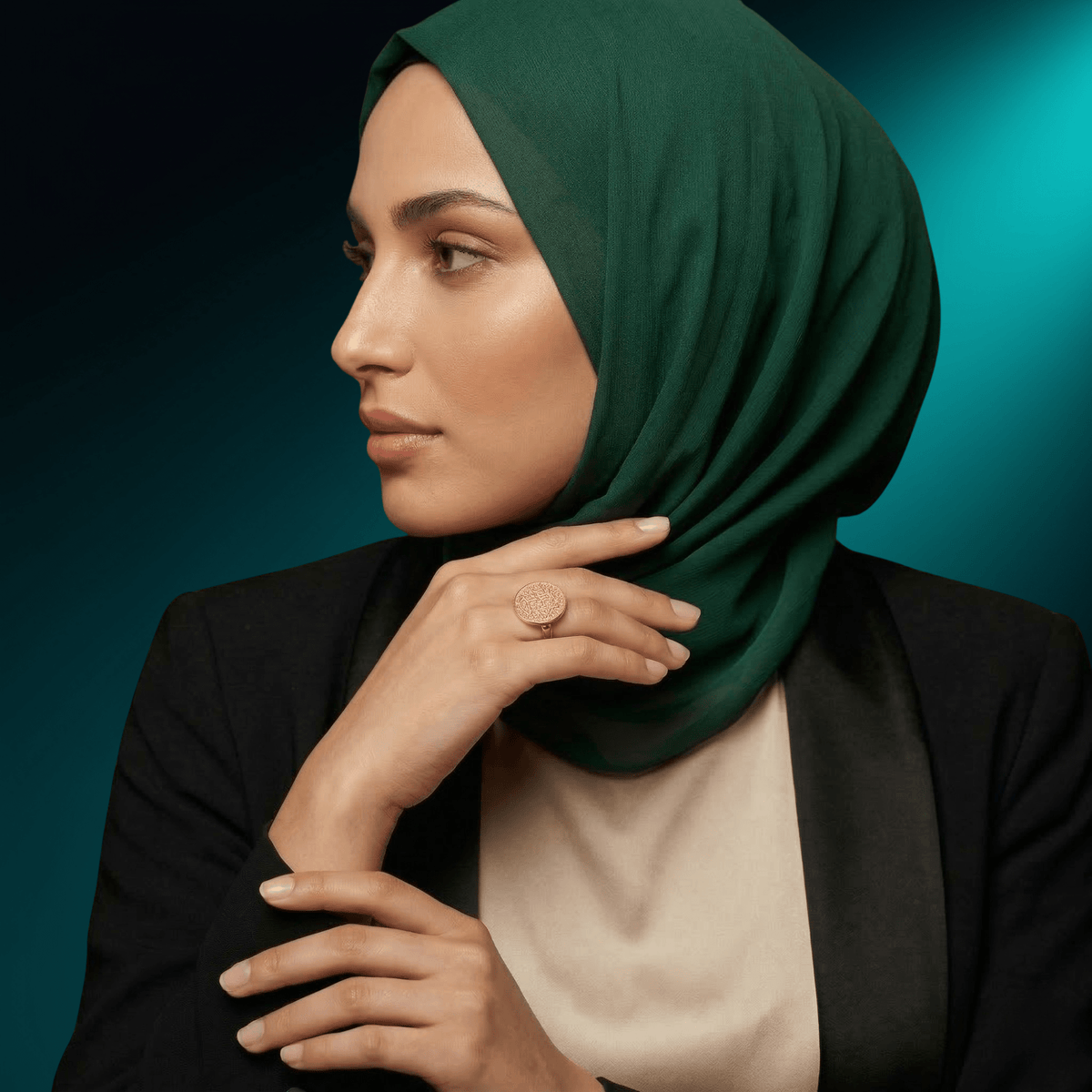 Woman in a green hijab wearing the NUUR Ayatul Kursi ring, side profile