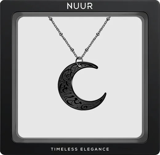NUUR Moon Necklace with an engraved black crescent pendant, in a black display frame